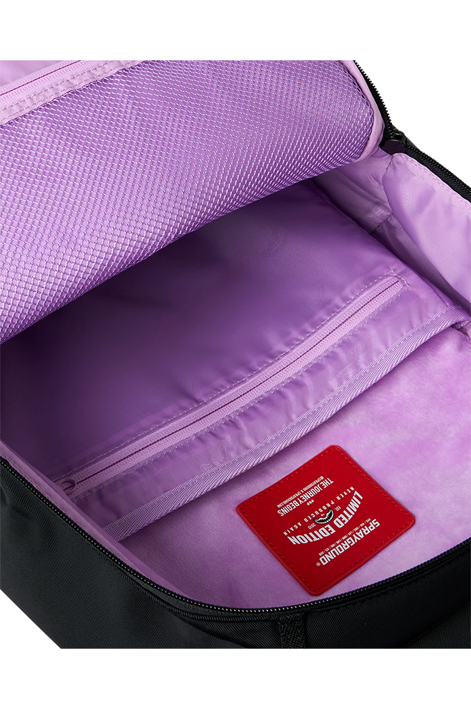 Close-up of the interior of a backpack showing a lavender purple mesh upper pocket, a matching zippered compartment, and a red interior brand label that reads 'Limited Edition'.