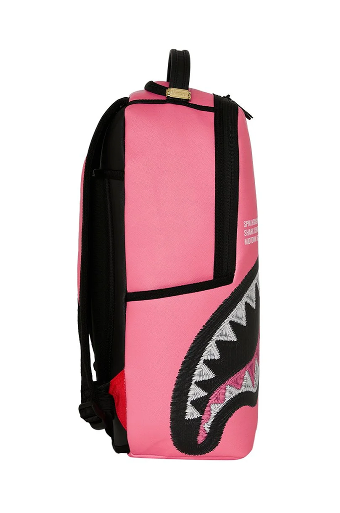 A pink and black Shark backpack featuring a large shark mouth graphic on the front, photographed against a solid white background.