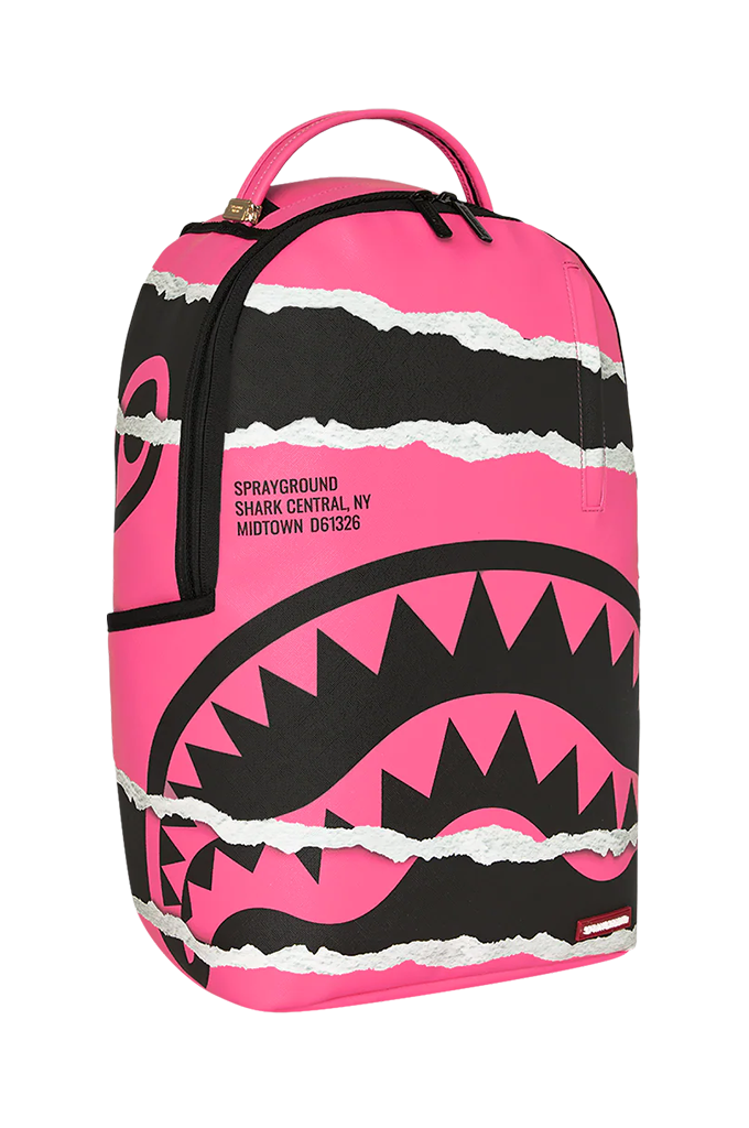 A Sprayground Shark Central backpack in vibrant pink and black, featuring a shark mouth graphic and torn paper effect, on a white background.