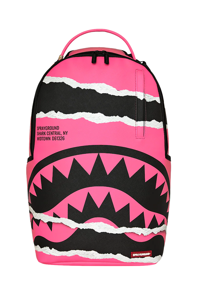 A pink and black spray backpack with a shark mouth graphic and white torn-paper accents, shown on a plain white background.