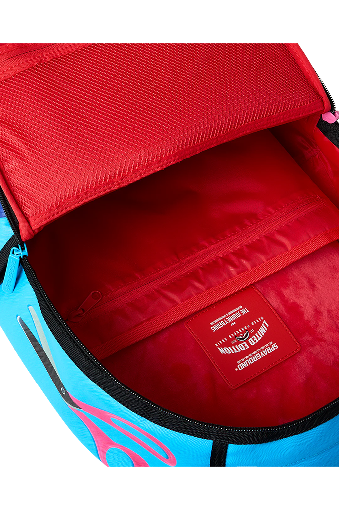 Close-up of the open interior of a bright blue and pink backpack, showing a red mesh back panel, red interior lining, black zipper, and a red interior label that reads 'Limited Edition'.