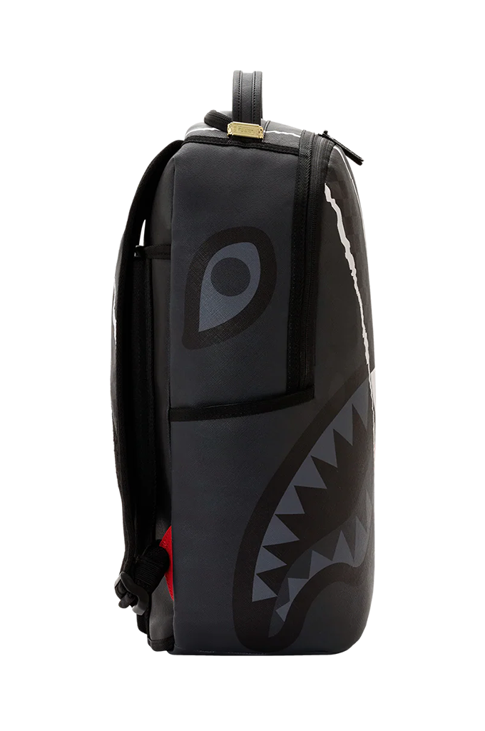 A black backpack featuring a shark-face graphic print with gray details, a large eye motif on the front pocket, and a small red accent near the bottom, shown against a plain white background.
