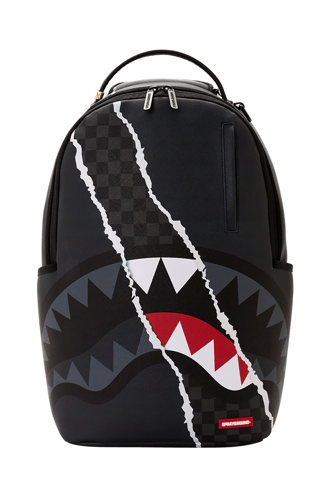 A black Sprayground backpack featuring a shark mouth graphic with white, red, and gray details, and a cracked white line design running vertically down the front.