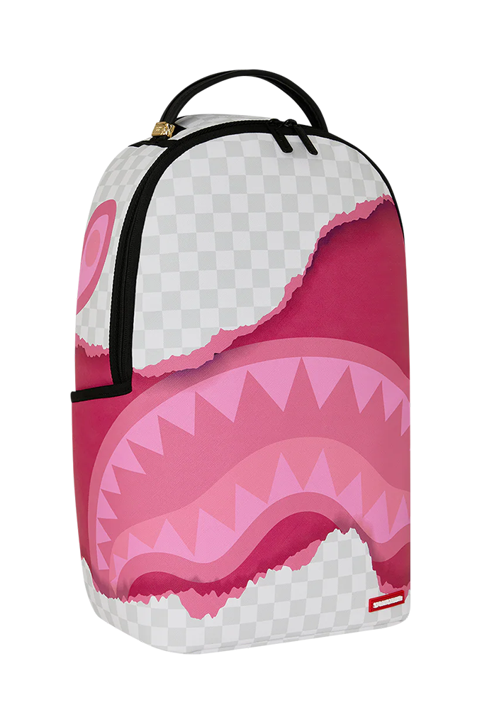 A backpack featuring a pink shark mouth graphic with a white and gray checkered background pattern, black straps, and a small red Spraycraft logo tag on the bottom right.