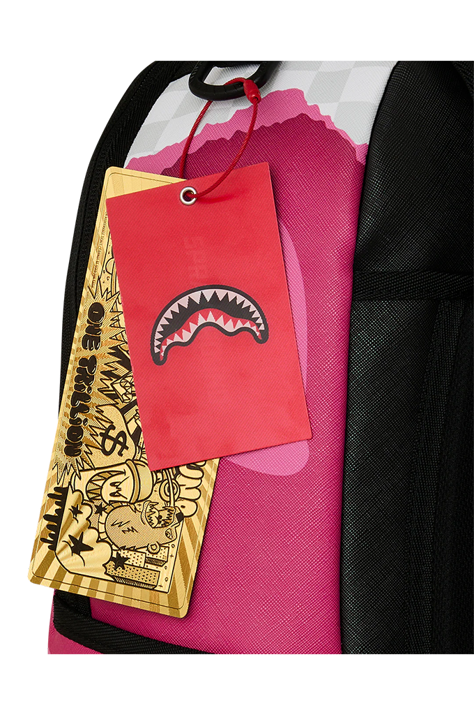 Close-up of a pink and black patterned backpack with a red hangtag featuring a shark mouth logo and a gold paper tag with cartoon graphics.