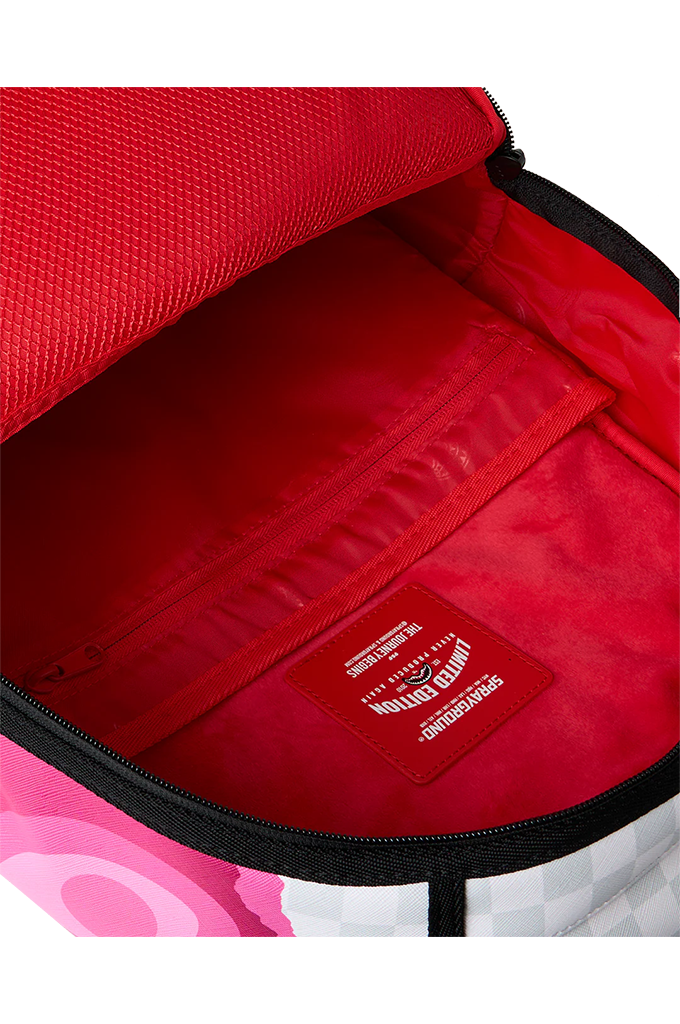 Close-up of the interior of a backpack showing a bright red mesh exterior lining and a red interior pocket with a red brand patch. The patch reads 'Limited Edition'. 