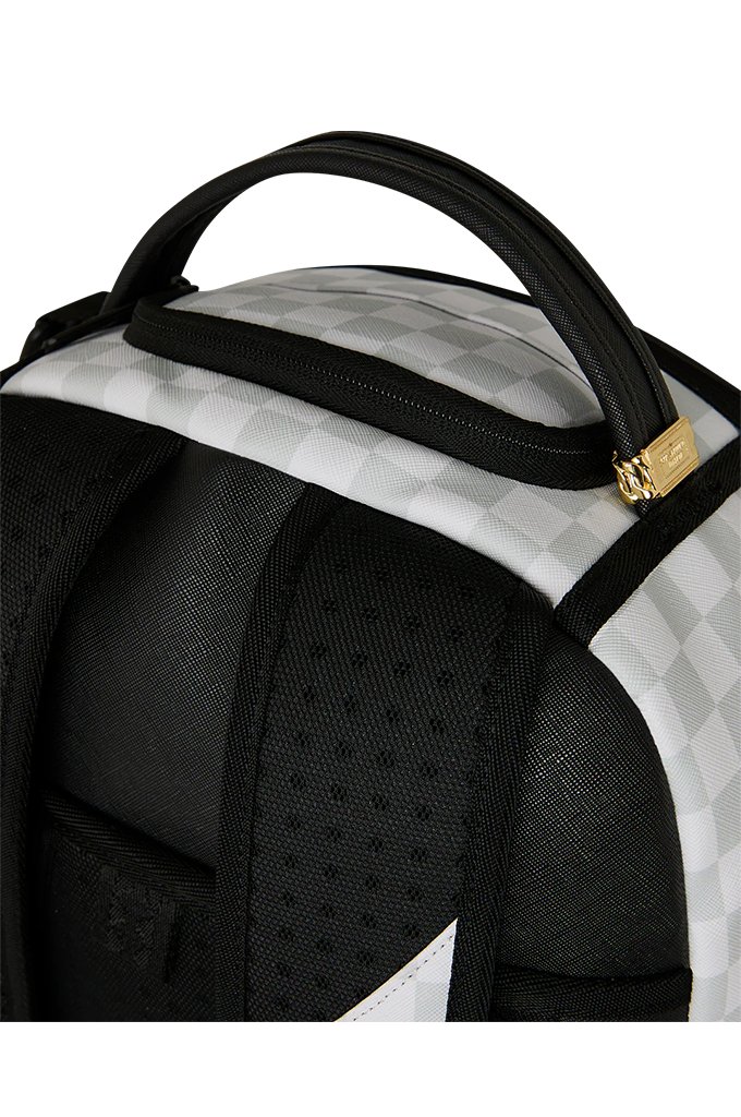 Close-up of a black and white checkered backpack with a black top handle and a small gold zipper pull on a white background.
