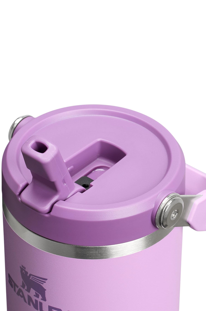 Close-up of a Stanley insulated tumbler in light purple/lavender with a matching lid and a silver metal band, on a white background.#color_lilac