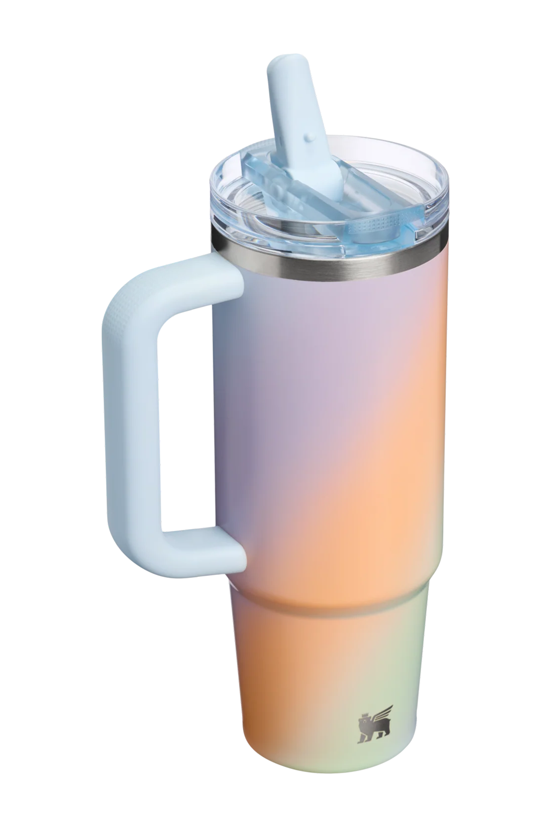A tall insulated tumbler with a handle, clear lid, and straw, shown on a plain white background. The tumbler has a soft iridescent gradient finish shifting from pale lavender to peach and mint, with a small deer logo near the bottom.#color_sunrise-spiral