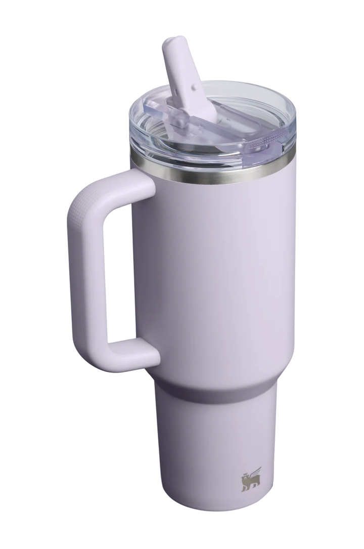 A light lavender insulated travel tumbler with a large integrated handle, a clear lid with a white straw, and a silver metal band near the lid, shown on a plain white background.#color_purple-dust