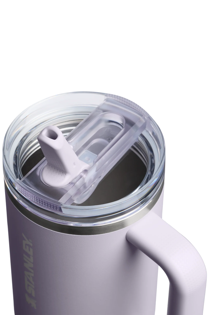 Close-up of a Stanley insulated tumbler with a clear lid and flip-up straw, shown on a white background.#color_purple-dust