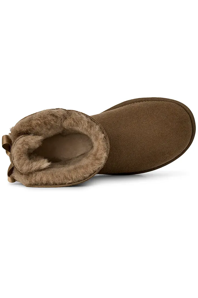 A single brown suede ankle boot with a soft tan shearling lining, shown from a side profile view on a white background.#color_light-bronze