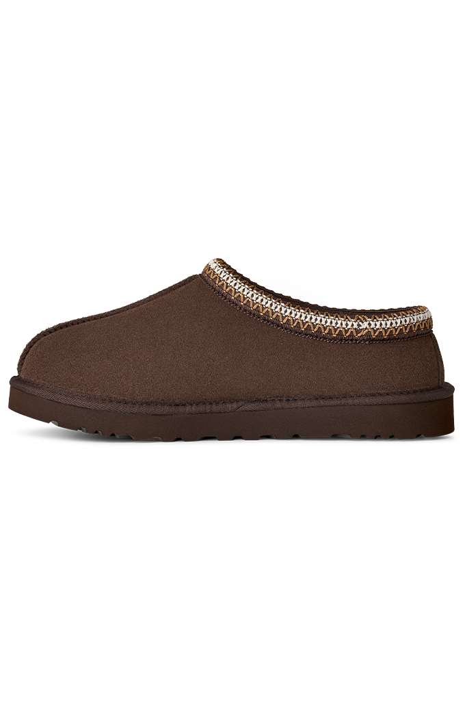 Brown slip-on UGG slipper with a decorative trim on a white background#color_dusted-cocoa