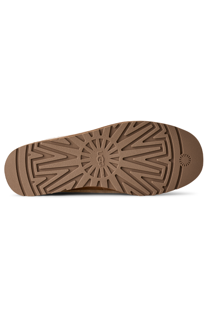 Close-up of a shoe sole with brown pattern on a white background