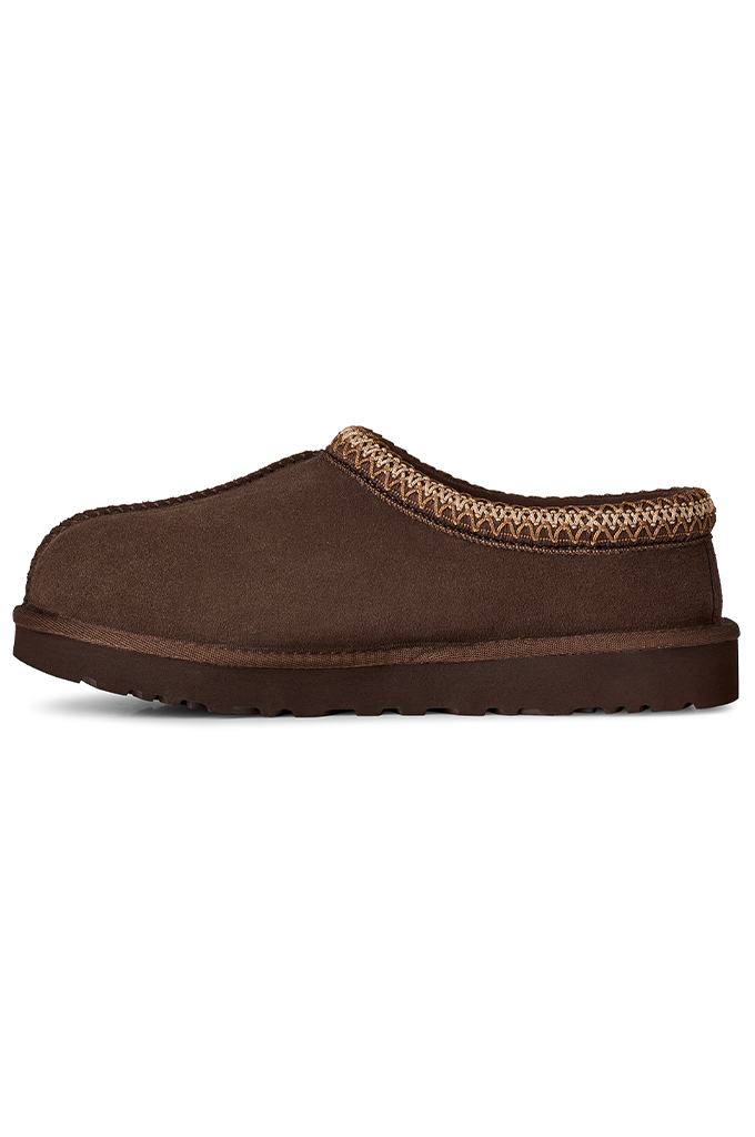 A single brown suede slip-on clog shoe with a braided tan and brown trim around the collar, shown from a side profile on a white background.#color_dusted-cocoa
