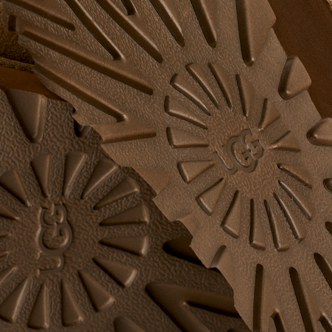 Close-up of brown textured material with a brand logo#color_light-bronze