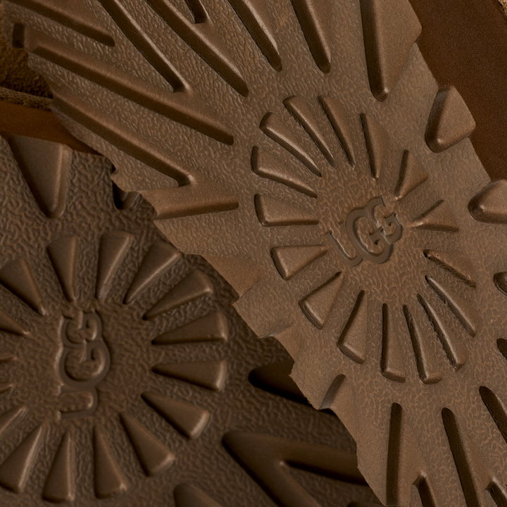 Close-up of brown textured material with a brand logo#color_light-bronze