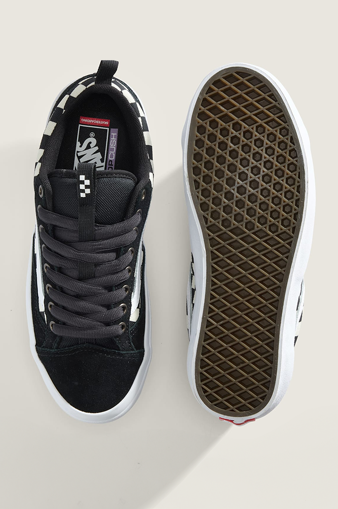 A pair of Vans platform sneakers shown from a top-down view, with one shoe displaying the black suede and canvas upper, gray laces, and white side stripe, and the other showing the brown waffle-patterned sole.