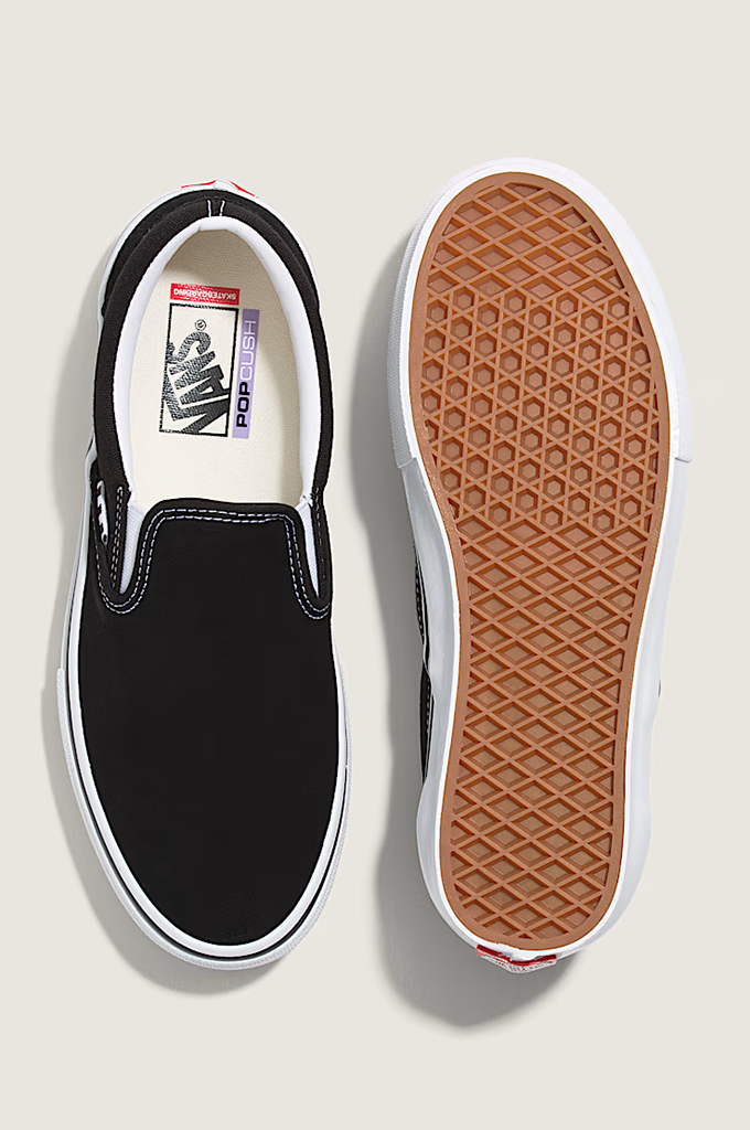 A pair of slip-on platform sneakers shown from the top and bottom, featuring a black canvas upper, white platform sole, and a brown textured rubber outsole.