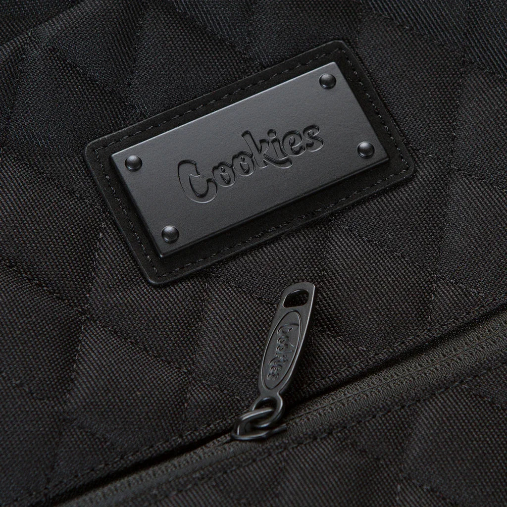 Black quilted backpack with embossed Cookies logo patch and branded zipper pull, skate and surf gear