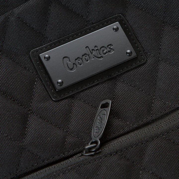 Black quilted backpack with embossed Cookies logo patch and branded zipper pull, skate and surf gear